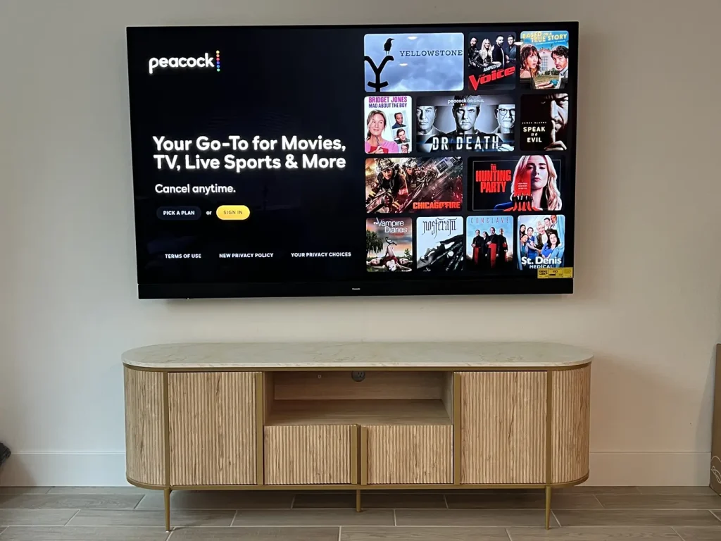 Flat screen mounted flush to the wall above a fluted-oak media console in a South of Market living room